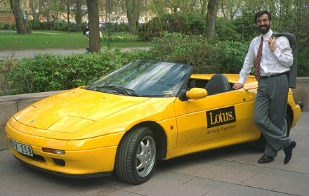 Chris stands next to a yellow Lotus Elan